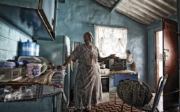 Woman in her kitchen using a Wonderbag slow cooker. Wonderbag