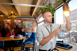 Man changing a lightbulb in Boulder.