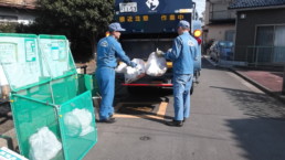 Sanitation workers picking up garbage.