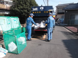 Sanitation workers picking up garbage.