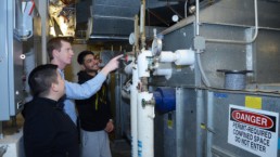 Men working on an HVAC system for energy efficiency.