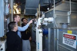 Men working on an HVAC system for energy efficiency.