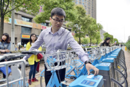 Chinese man using a bike-sharing program in Wuhan.