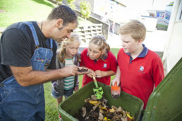 Man teaching children how to recycle in Auckland.