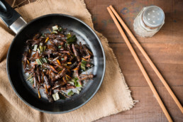 Fried grasshopper with pandan Season with salt, pepper and soy sauce. on old wooden table