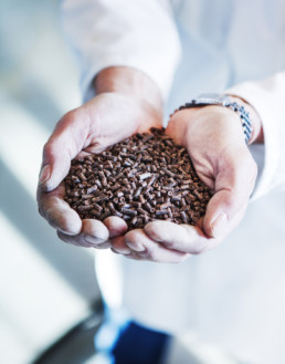 Man holding FeedKind an aquaculture feed produced via natural fermentation