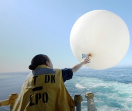 Woman using an early warning and forecasting device.