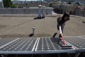 Woman cleaning solar panels.