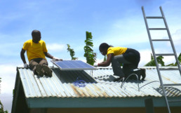 Men installing solar panels designed by Mobisol in Africa.