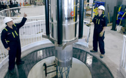 Men working with a Temporal Power’s flywheel mechanical battery.