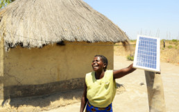 Woman using a solar panel crowdfunded. TRINE