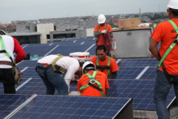 Men working and installing solar panels in Washington D.C.