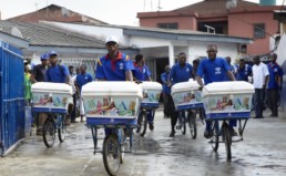 Men delivering rice on bikes in Nigeria.