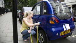 Woman charging her electric vehicle.