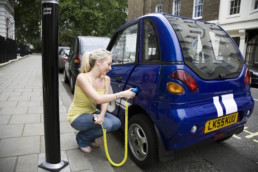 Woman charging her electric vehicle.