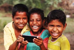 Boys using a smartphone for e-learning.