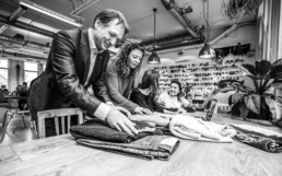 Man and women folding MUD Jeans.