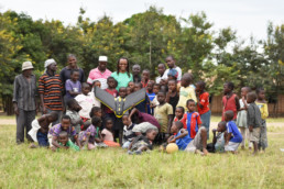 Group photo of adults and children in Tanzania.