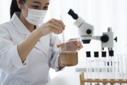 Woman in a laboratory testing a sample.