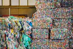 Stacked bales of plastic for recycling. Markets.