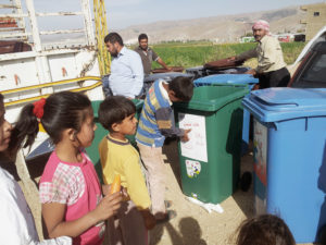 Syrian refugees sorting recycling for money.
