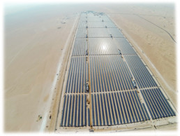 Aerial view of a solar panel farm in the Dubai desert.