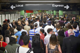 Men and women waiting for a subway in New York City.