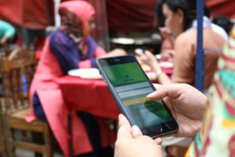 Woman using her mobile phone for insurance.