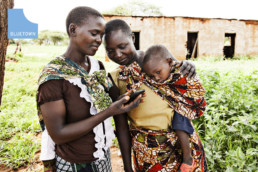 Family using a smartphone, thanks to Bluetown wireless internet stations.