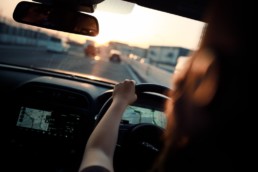 Woman driving a car using the carpooling Bynd.