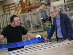 Two men looking at a new solar panel in Aarhus Kommune