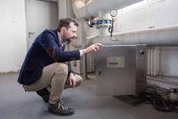 Man looking at an air compressor unit installed with Enersize sensors.