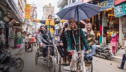 People on tricycles on the roads wearing Picture clothing made from organic cotton and recycled polyester