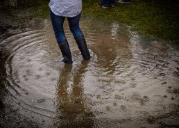 Woman surrounded by a puddle due to climate change.