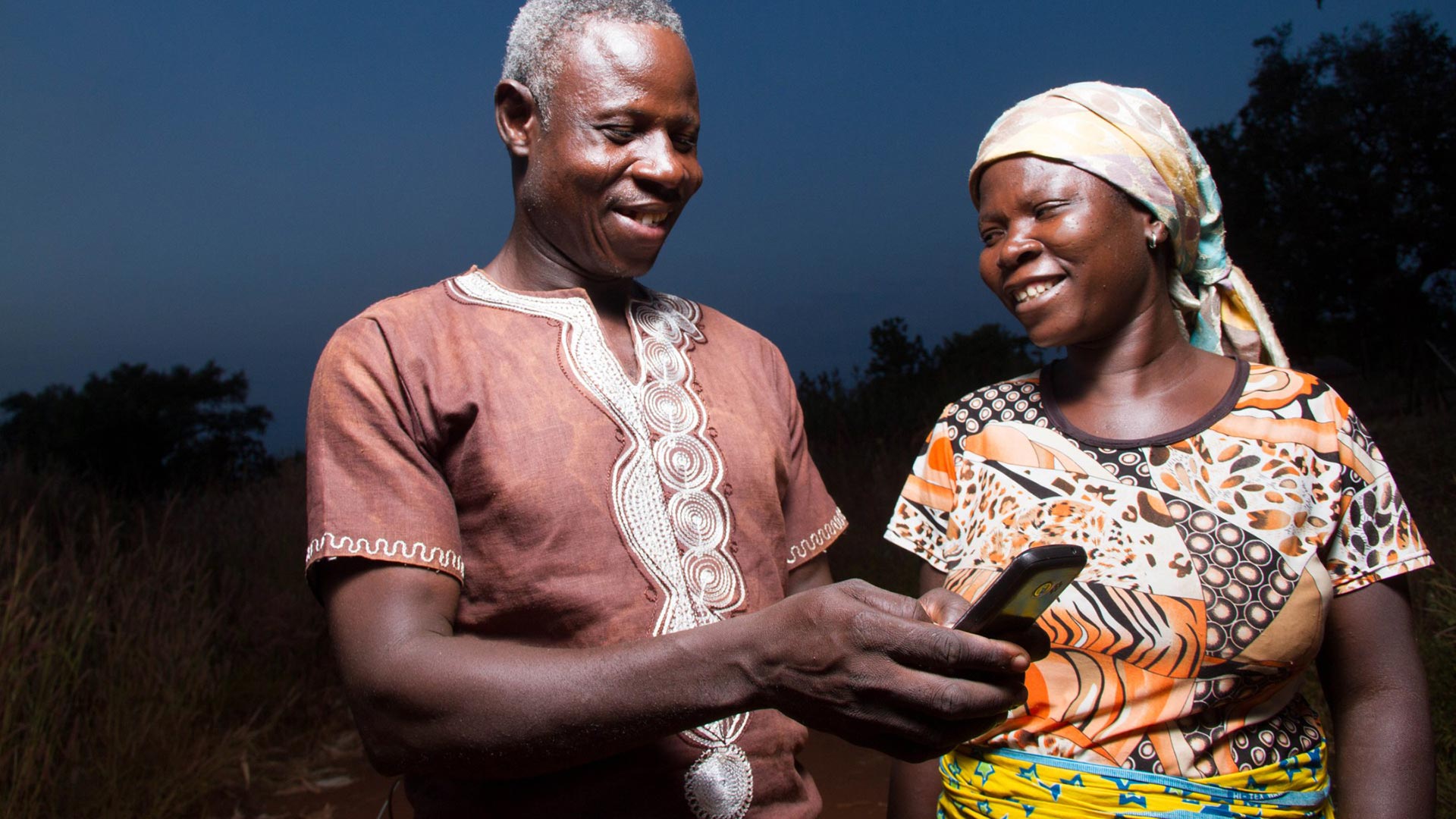 Farmers in Africa using a a phone for sms updates